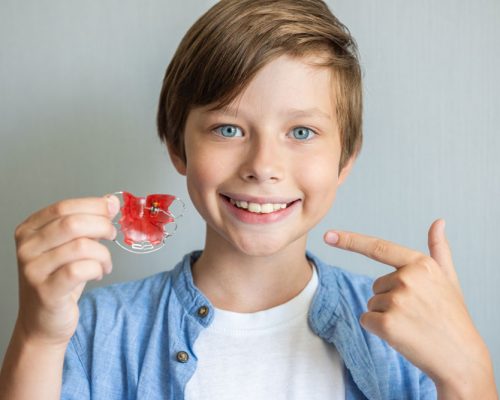 teenage-boy-wearing-orthodontic-braces-and-showing-2024-10-21-23-30-19-utc